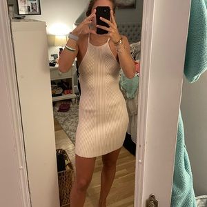 Adorable tan dress with small cut outs on the side